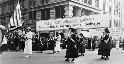 Women, marching for suffrage, use the words of Woodrow Wilson to further their cause. https://www.history.com/topics/us-presidents/woodrow-wilson/pictures/woodrow-wilson/women-suffrage-parade-supporting-wilson