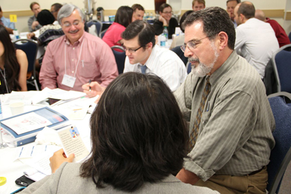 A group sits at a table while working on the simulation