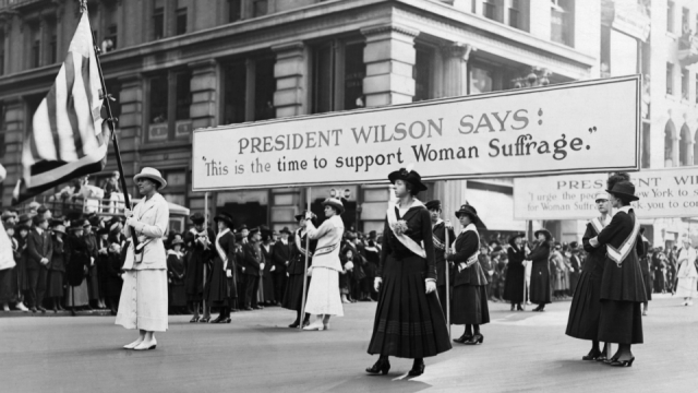 Women, marching for suffrage, use the words of Woodrow Wilson to further their cause. https://www.history.com/topics/us-presidents/woodrow-wilson/pictures/woodrow-wilson/women-suffrage-parade-supporting-wilson